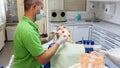 Portrait of male dentist inspecting mouth of young blonde woman