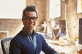 Portrait Of Male Designer Working At Desk In Modern Office