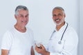 Portrait of male doctor giving pills to senior man Royalty Free Stock Photo