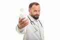 Portrait of male doctor handing a bottle of water