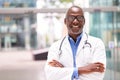 Portrait Of Male Doctor With Stethoscope Wearing White Coat Standing In Modern Hospital Building Royalty Free Stock Photo