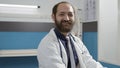 Portrait of male doctor with uniform using laptop in cabinet Royalty Free Stock Photo