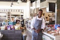 Portrait Of Male Employee Working In Delicatessen