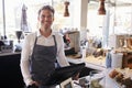 Portrait Of Male Employee Working At Delicatessen Checkout Royalty Free Stock Photo