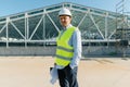 Portrait of male engineer at construction site, builder with blueprint. Building, development, teamwork and people concept Royalty Free Stock Photo