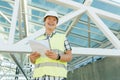 Portrait of male engineer at construction site. Builder looks at the plan of the construction site. Building, development, teamwor Royalty Free Stock Photo