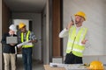 Portrait of male engineer holding walkie talkie and male engineer female with working together inspection housing estate Royalty Free Stock Photo