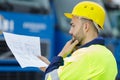 portrait male engineer studying blueprint