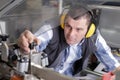 portrait male engineer working on machine in factory Royalty Free Stock Photo