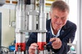 Portrait Of Male Engineer Working On Machine In Factory Royalty Free Stock Photo