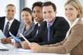 Portrait Of Male Executive Attending Office Meeting With Colleagues