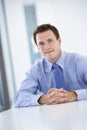 Portrait Of Male Executive Working At Desk In Office