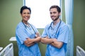 Portrait of male and female nurse standing in ward Royalty Free Stock Photo