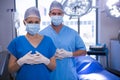 Portrait of male and female nurse wearing surgical mask in operation theater Royalty Free Stock Photo
