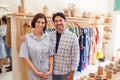 Portrait Of Male And Female Owners Of Fashion Store Standing In Front Of Clothing On Rails Royalty Free Stock Photo