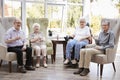 Portrait Of Male And Female Residents Sitting In Chairs In Lounge Of Retirement Home Royalty Free Stock Photo