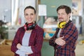 portrait male and female workers wearing earmuffs around neck