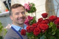 portrait male florist holding bunch red roses Royalty Free Stock Photo