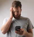 Portrait of a male freaking out because of a text message