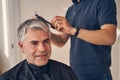 Portrait of male getting new fashionable hairstyle Royalty Free Stock Photo