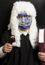 Portrait of male jewish lawyer with painted Israel flag holding judge gavel and book Royalty Free Stock Photo