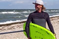 Portrait of a male kite foil surfer with a board on the beach Royalty Free Stock Photo