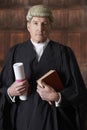 Portrait Of Male Lawyer In Court Holding Brief And Book