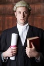 Portrait Of Male Lawyer In Court Holding Brief And Book