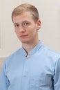 Portrait of a male masseur in blue apron