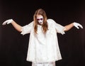 Portrait of male mime artist, isolated on black background. Man dressed like an angel is standing with risen hands and Royalty Free Stock Photo