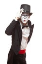 Portrait of a male mime artist performing,  on white background. Mime holds his hat by hand and looks at camera Royalty Free Stock Photo