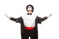 Portrait of a male mime artist performing, isolated on white background. Standing with his hands raised. Symbol of glory