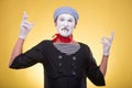 Portrait of male mime isolated on yellow
