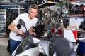 Portrait of male motorcyclist looking on the bike in the store