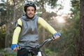 Portrait of male mountain biker riding bicycle in the forest Royalty Free Stock Photo