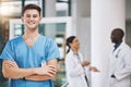 Portrait of a male nurse with his team in the background in the hospital. Happy, smiling and confident nurse with Royalty Free Stock Photo