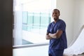 Portrait Of Male Nurse Wearing Scrubs In Exam Room Royalty Free Stock Photo