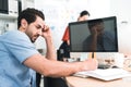 Portrait of male office worker feeling bored and unfocused sitting at his desk stress of work, working lifestyle, stressful work, Royalty Free Stock Photo