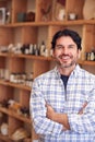 Portrait Of Male Owner Of Gift Store Standing In Front Of Shelves With Cosmetics And Candles Royalty Free Stock Photo