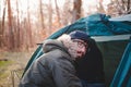 Portrait of a male person at a tent in late autumn