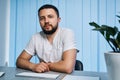 Portrait of male physician with self-confidence at private clinic office. Interior of workplace Royalty Free Stock Photo