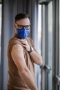 Portrait of male professional wearing mask got vaccinated against covid19