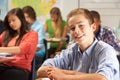 Portrait Of Male Pupil Studying At Desk In Classroom Royalty Free Stock Photo