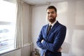 Portrait Of Male Realtor Looking At House Details In Property For Renovation