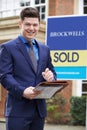 Portrait Of Male Realtor Standing Outside Residential Property Royalty Free Stock Photo