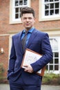 Portrait Of Male Realtor Standing Outside Residential Property Royalty Free Stock Photo