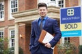 Portrait Of Male Realtor Standing Outside Residential Property Royalty Free Stock Photo