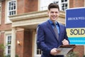 Portrait Of Male Realtor Standing Outside Residential Property W Royalty Free Stock Photo