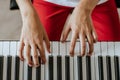 Portrait of male's white hands playing on the piano