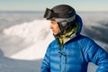 portrait of male skier in jacket and helmet on his head